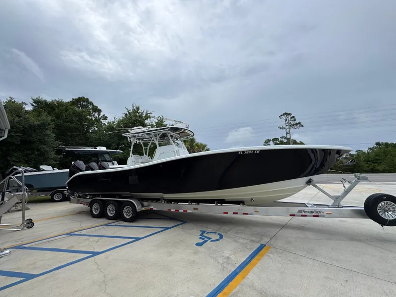 Slide: The Image of 2021 Yellowfin 36 Offshore boat on trailer, parked outdoors under cloudy sky. - 8