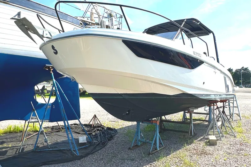 Slide: The Image of 2022 Beneteau Flyer 8 SUNdeck boat on stands, displayed outdoors. - 12