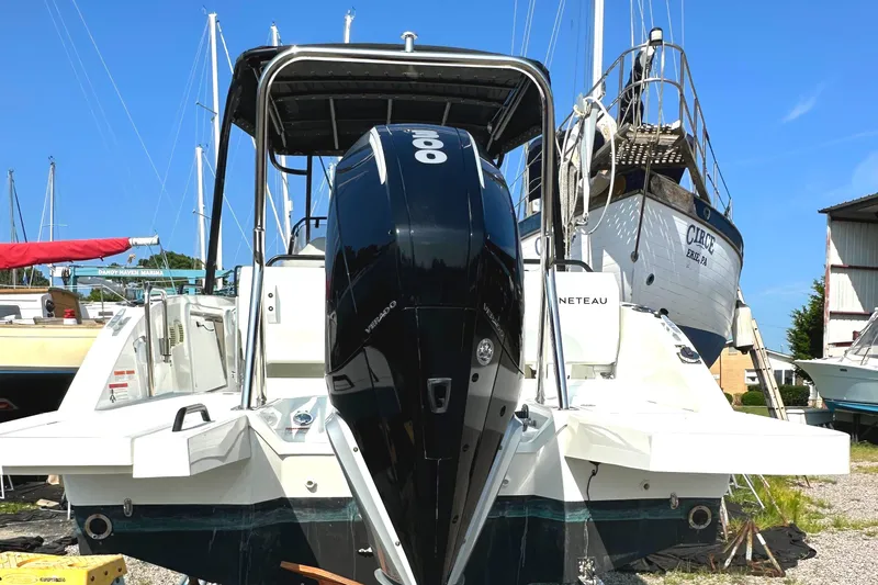 Slide: The Image of 2022 Beneteau Flyer 8 SUNdeck boat with powerful outboard motor, docked in a marina. - 13