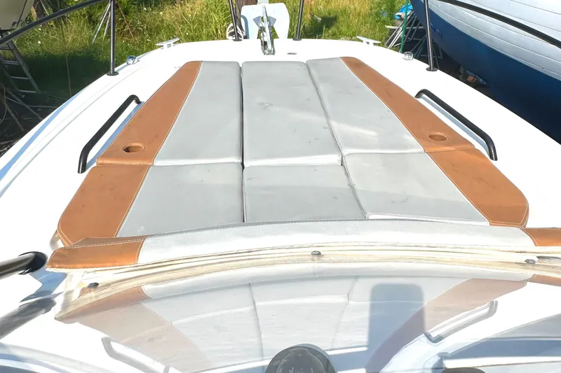 Slide: The Image of 2022 Beneteau Flyer 8 SUNdeck with cushioned sunbathing area, featuring brown and gray upholstery. - 14