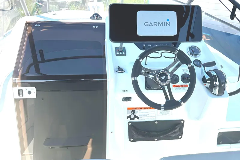 Slide: The Image of 2022 Beneteau Flyer 8 SUNdeck cockpit with Garmin navigation system and modern steering controls. - 21