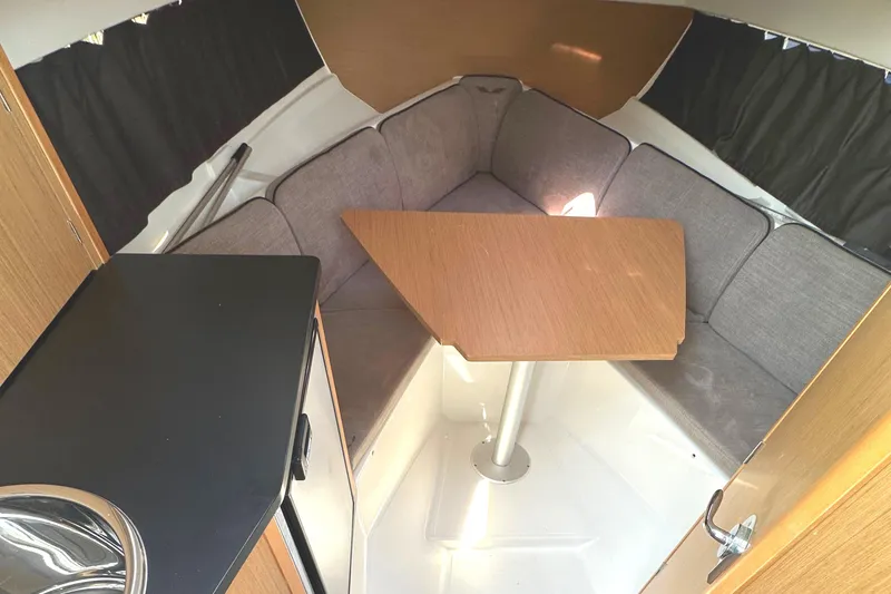 Slide: The Image of Interior of 2022 Beneteau Flyer 8 SUNdeck with cozy seating and wooden table. - 29