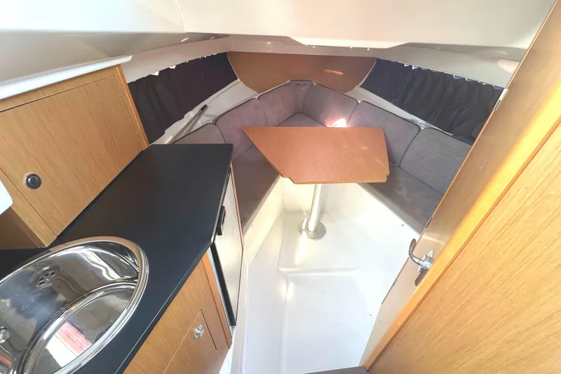 Slide: The Image of 2022 Beneteau Flyer 8 SUNdeck interior with kitchenette, seating, and table. - 32