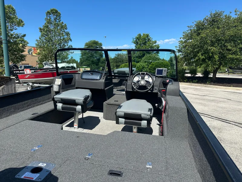 Slide: The Image of 2016 Lowe FM 165 Pro WT boat interior with dual seats and steering console. - 1