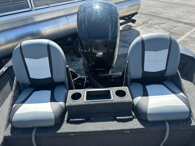 Slide: The Image of 2016 Lowe FM 165 Pro WT boat seats and motor, featuring dual cup holders. - 2