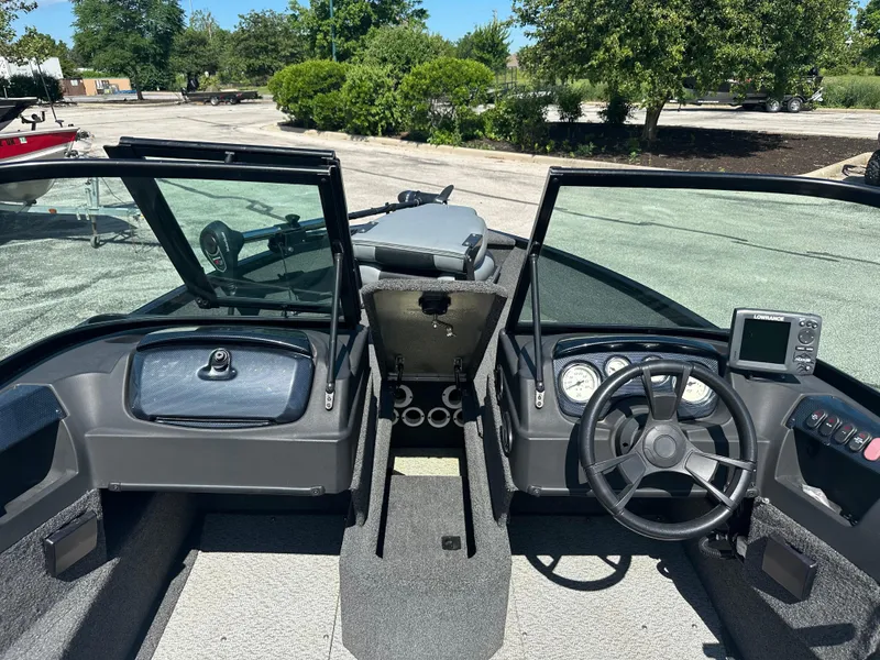 Slide: The Image of 2016 Lowe FM 165 Pro WT boat interior with steering wheel and dashboard controls. - 3
