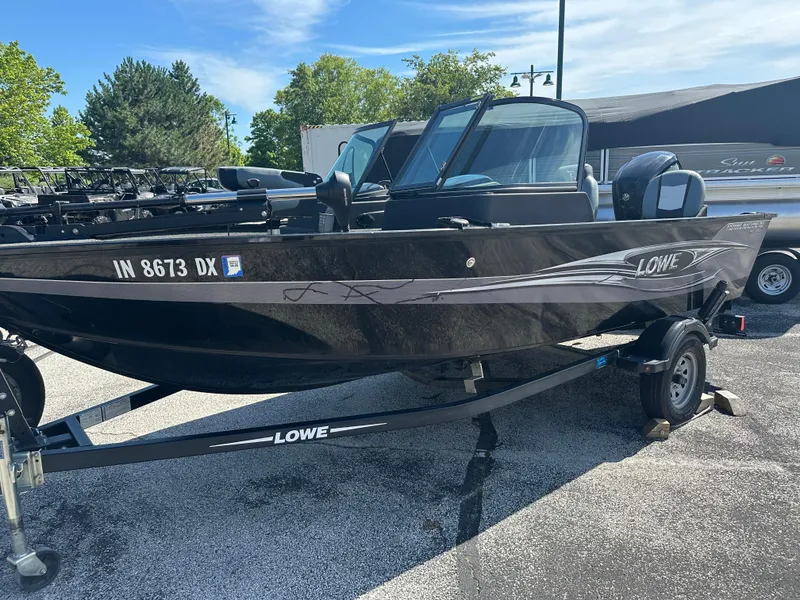 Slide: The Image of 2016 Lowe FM 165 Pro WT fishing boat on trailer, parked outdoors. - 5