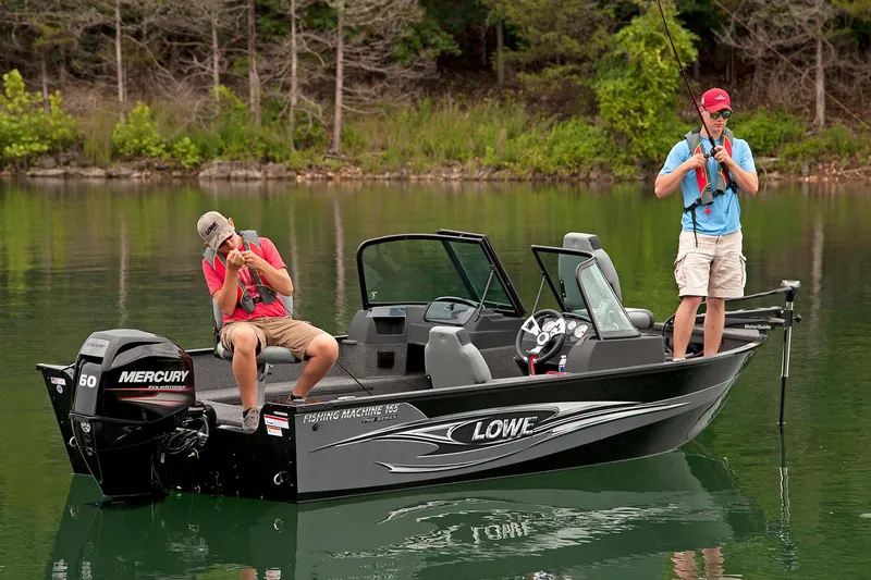 Slide: The Image of Manufacturer Provided Image: 2016 Lowe FM 165 Pro WT fishing boat on a lake with two anglers. - 7