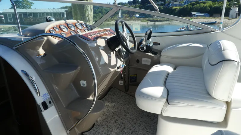 Slide: The Image of 2002 Maxum 3100 SCR boat interior with white seating and control panel. - 10