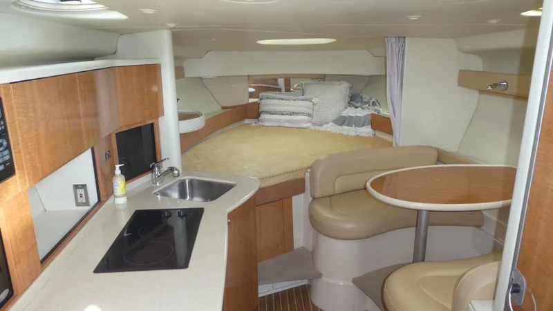 Slide: The Image of Interior of 2002 Maxum 3100 SCR yacht with kitchen, seating, and bed. - 11
