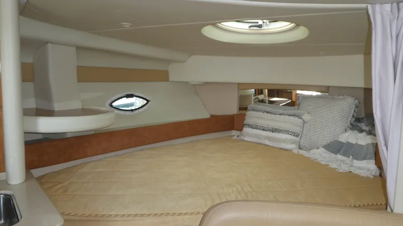 Slide: The Image of Interior cabin of 2002 Maxum 3100 SCR boat with cozy bedding and porthole window. - 14