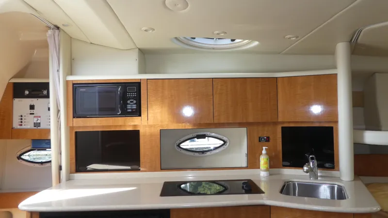 Slide: The Image of Interior of 2002 Maxum 3100 SCR yacht with kitchenette, microwave, and sink. - 15