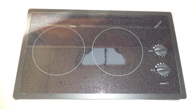 Slide: The Image of Ceramic cooktop with two burners and control knobs, labeled "Princess" and "Ceran." - 18