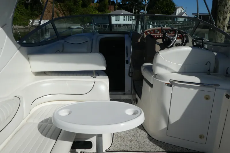 Slide: The Image of 2002 Maxum 3100 SCR boat interior with white seating and steering area. - 19