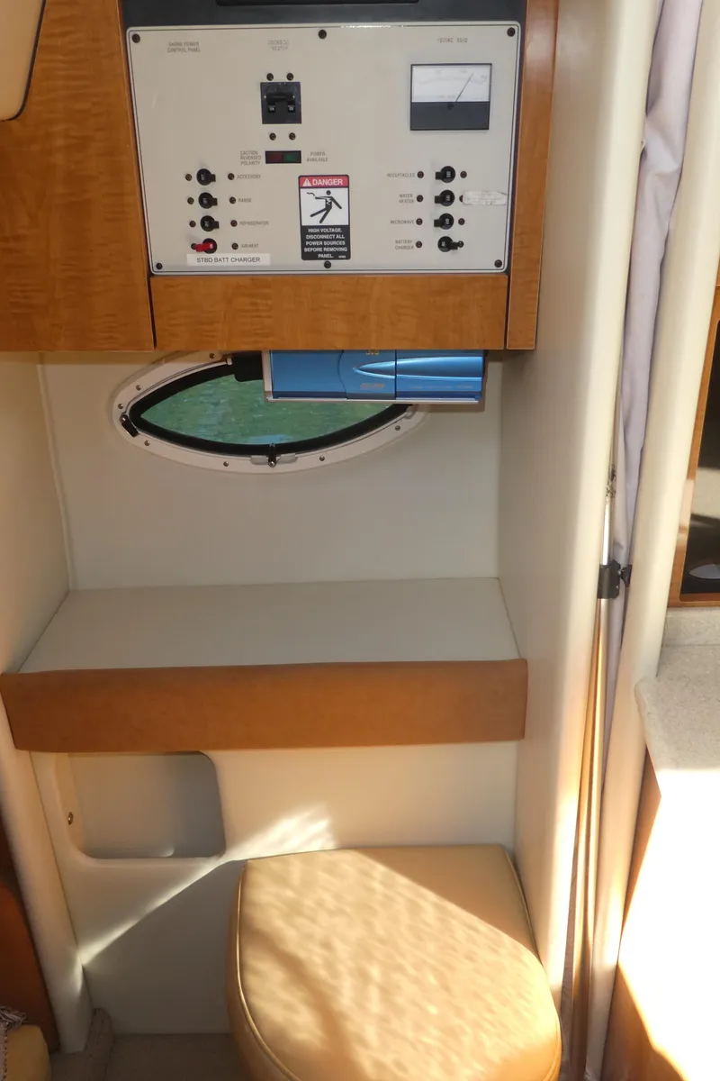 Slide: The Image of 2002 Maxum 3100 SCR cabin interior with control panel and seating area. - 30