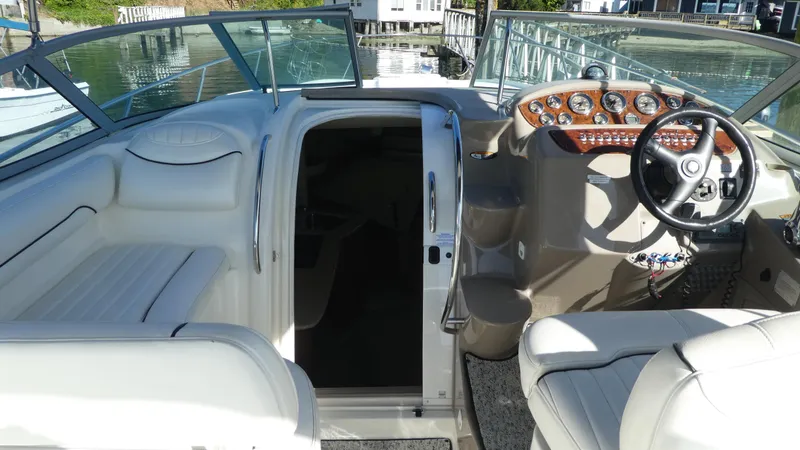 Slide: The Image of 2002 Maxum 3100 SCR boat interior with steering wheel, dashboard, and seating area. - 7