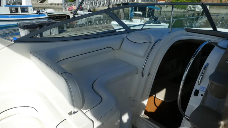 Slide: The Image of 2002 Maxum 3100 SCR boat interior with white seating and open cabin door. - 8