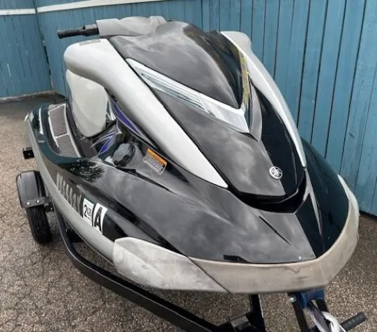 Slide: The Image of 2008 Yamaha WaveRunner FX HO jet ski on trailer, parked by blue fence. - 3