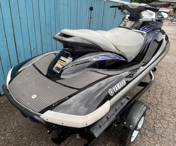 Slide: The Image of 2008 Yamaha WaveRunner FX HO jet ski on trailer, parked by blue fence. - 6