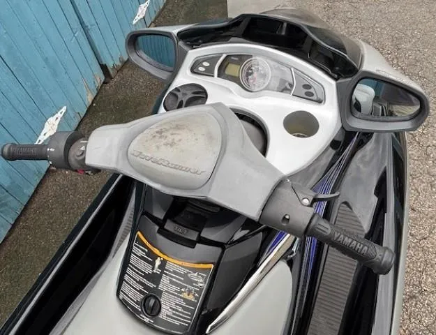 Slide: The Image of 2008 Yamaha WaveRunner FX HO dashboard and handlebars, parked near a blue fence. - 7