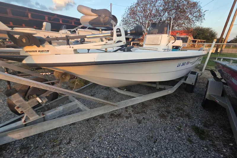 Slide: The Image of 2002 Sprint Salt-Max boat on trailer, equipped with Minn Kota motor, parked outdoors. - 11