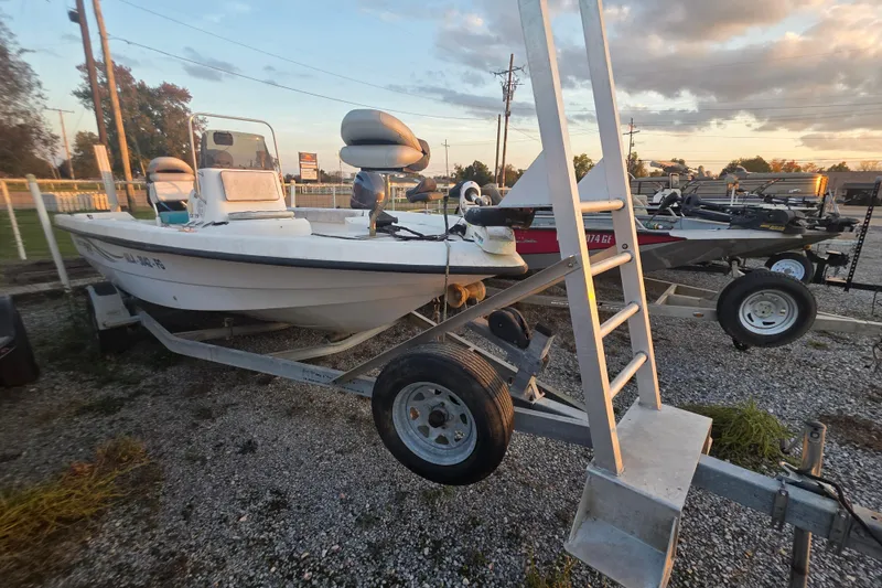 Slide: The Image of 2002 Sprint Salt-Max boat on trailer at sunset, parked on gravel lot. - 12