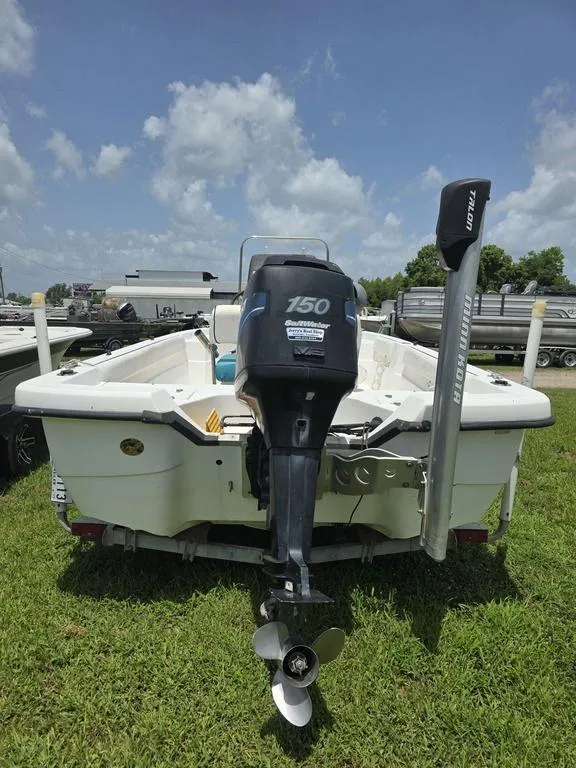 Slide: The Image of 2002 Sprint Salt-Max boat with outboard motor on grassy field under blue sky. - 3