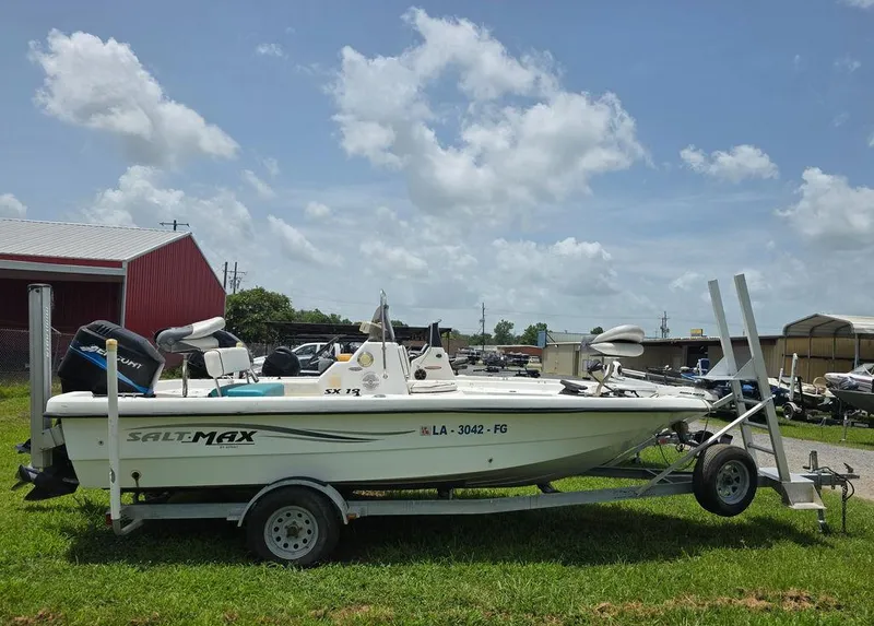 Slide: The Image of 2002 Sprint Salt-Max boat on trailer, parked on grass under a cloudy sky. - 4