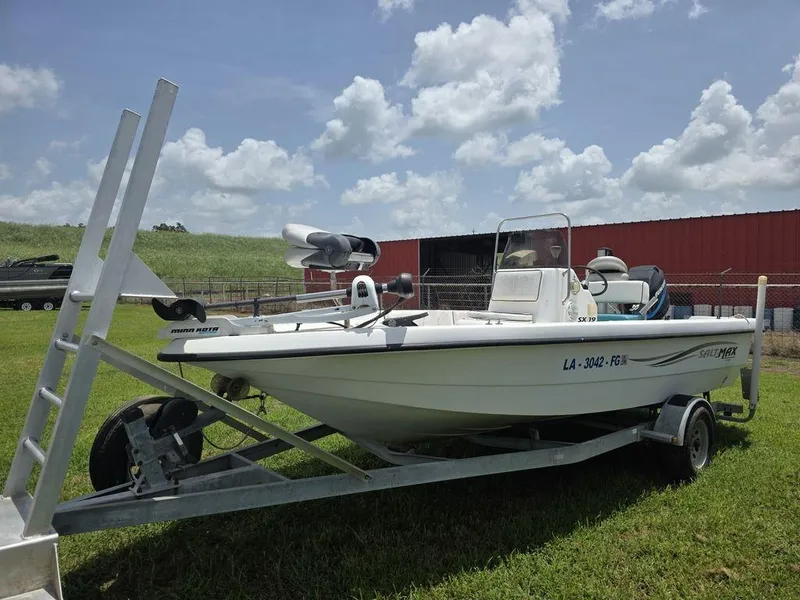 Slide: The Image of 2002 Sprint Salt-Max boat on trailer, parked on grass under a cloudy sky. - 5
