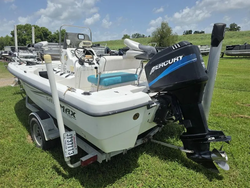 Slide: The Image of 2002 Sprint Salt-Max boat with Mercury outboard motor on grassy field. - 6