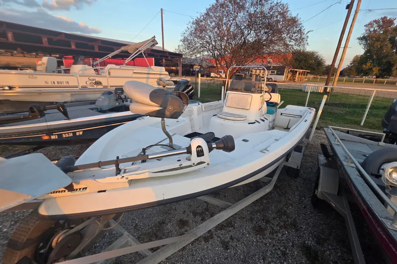 Slide: The Image of 2002 Sprint Salt-Max boat on trailer, parked outdoors, with other boats nearby. - 8
