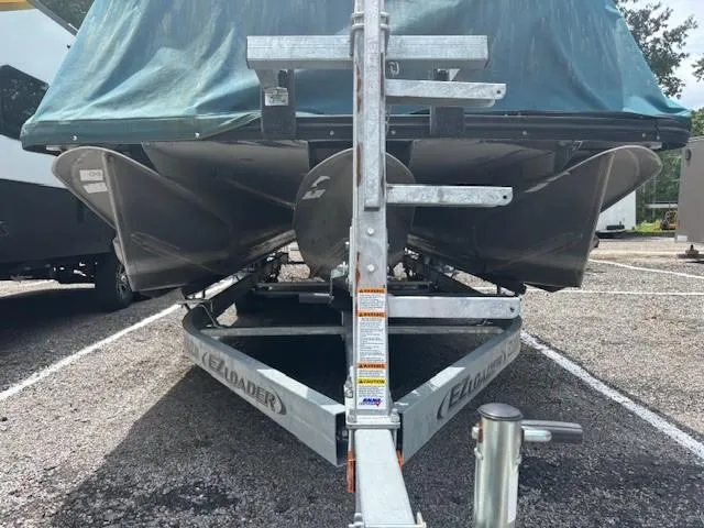 Slide: The Image of 2021 Avalon Catalina Quad Lounger boat on trailer, covered and parked outdoors. - 11