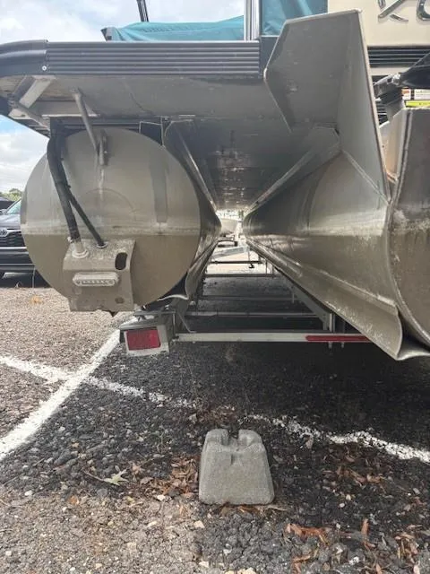 Slide: The Image of 2021 Avalon Catalina Quad Lounger pontoon boat underside view in a parking lot. - 12