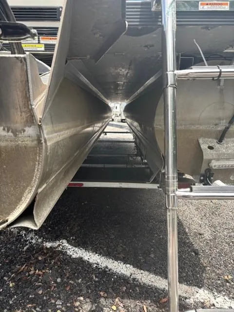 Slide: The Image of Underneath view of a 2021 Avalon Catalina Quad Lounger pontoon boat on a trailer. - 13