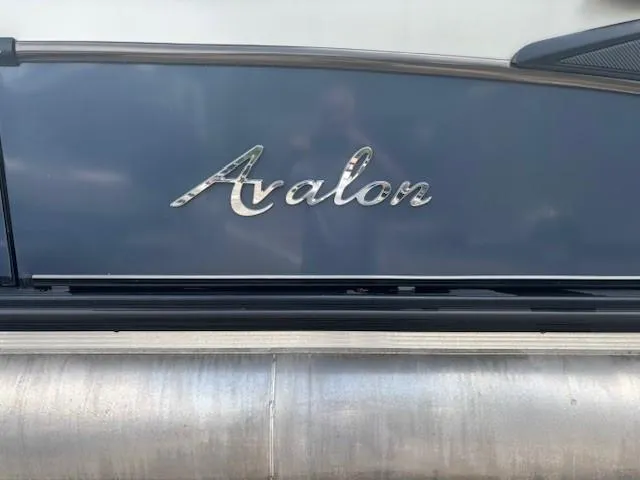 Slide: The Image of 2021 Avalon Catalina Quad Lounger boat, sleek design with metallic logo. - 15