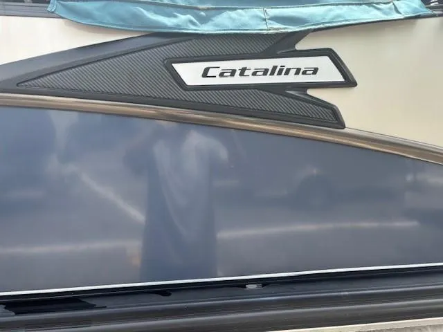 Slide: The Image of 2021 Avalon Catalina Quad Lounger boat side view with logo detail. - 16