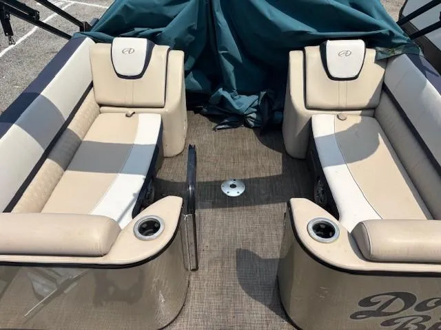 Slide: The Image of 2021 Avalon Catalina Quad Lounger interior with beige seating and cup holders. - 19