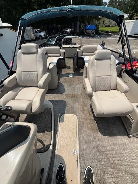 Slide: The Image of 2021 Avalon Catalina Quad Lounger boat interior with beige seating and canopy. - 20