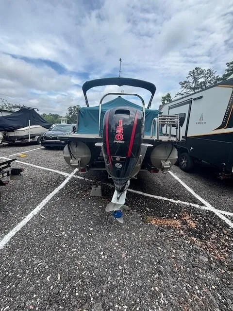 Slide: The Image of 2021 Avalon Catalina Quad Lounger boat in parking lot, rear view with outboard motor. - 4
