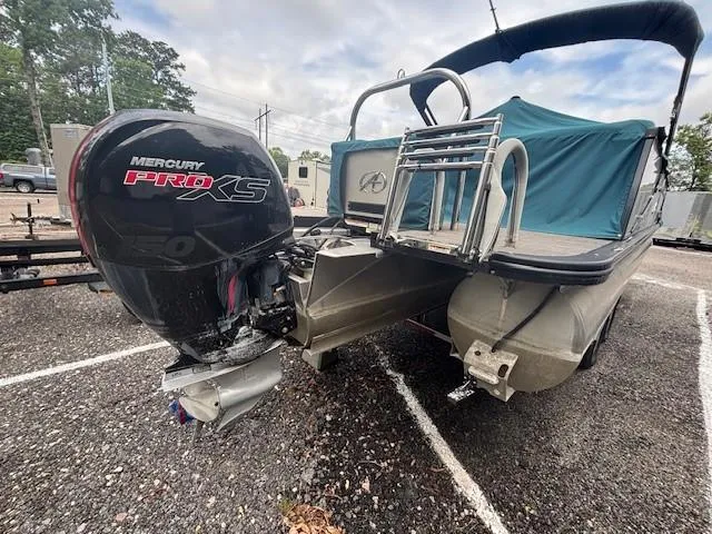 Slide: The Image of 2021 Avalon Catalina Quad Lounger boat with Mercury Pro XS engine, parked on gravel. - 5