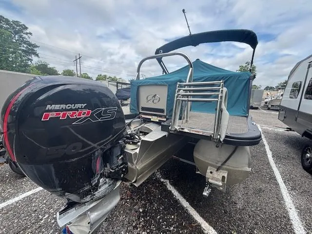 Slide: The Image of 2021 Avalon Catalina Quad Lounger boat with Mercury Pro XS engine, parked outdoors. - 6