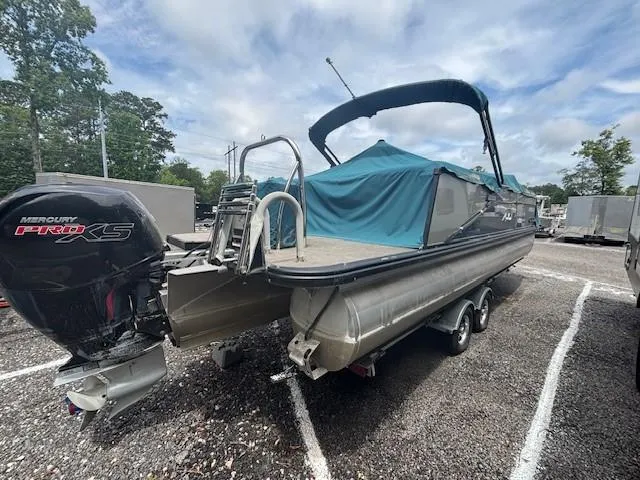 Slide: The Image of 2021 Avalon Catalina Quad Lounger boat with Mercury Pro XS engine, parked on gravel. - 8