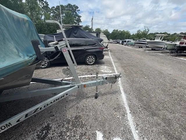 Slide: The Image of Parking lot with boats and trailers, featuring a 2021 Avalon Catalina Quad Lounger. - 9