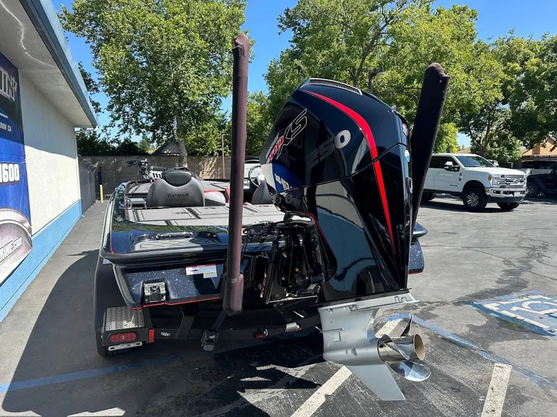 Slide: The Image of 2024 Caymas XS 20 Pro boat with powerful outboard motor in a parking lot. - 10