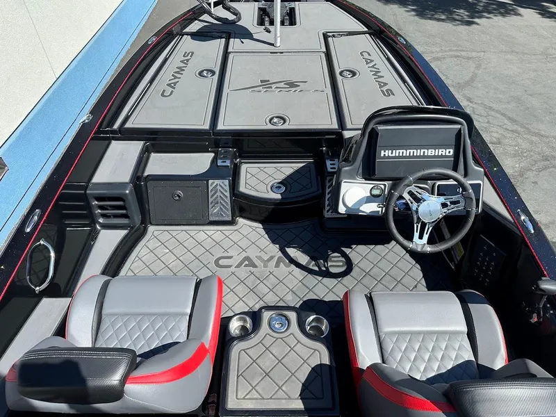 Slide: The Image of 2024 Caymas XS 20 Pro boat interior with steering wheel and seating, featuring Humminbird electronics. - 14