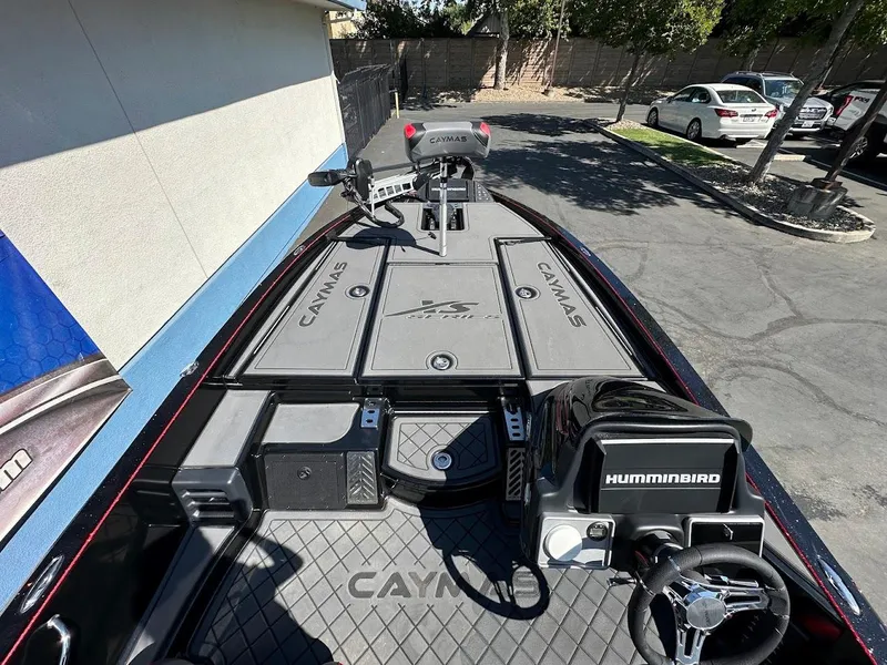 Slide: The Image of 2024 Caymas XS 20 Pro boat interior with Humminbird electronics and steering wheel. - 15