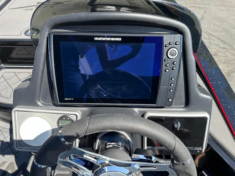 Slide: The Image of 2024 Caymas XS 20 Pro dashboard with Humminbird Helix 12 display and steering wheel. - 19