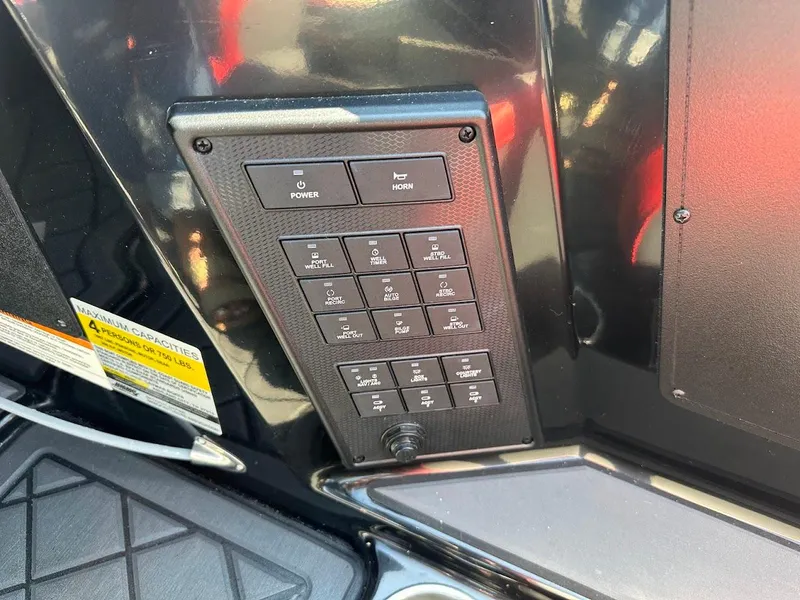 Slide: The Image of Control panel of 2024 Caymas XS 20 Pro boat with various switches and labels. - 20