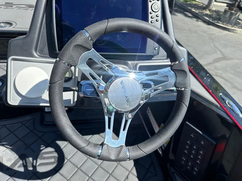 Slide: The Image of Steering wheel of 2024 Caymas XS 20 Pro boat with modern dashboard controls. - 21