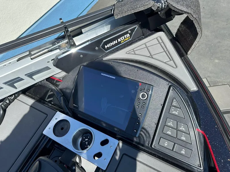 Slide: The Image of 2024 Caymas XS 20 Pro boat dashboard with Humminbird display and Minn Kota Ultrex system. - 27